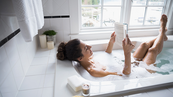 Woman reading in the bathtub