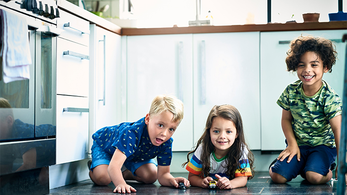 Three children playing in the kitchen