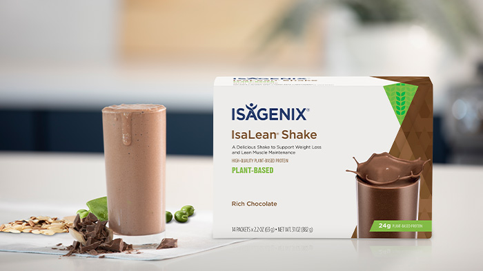 Rich Chocolate IsaLean Shake Plant-Based box and glass of mixed shake with fresh ingredients on the side