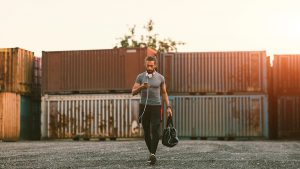 man going to the gym with his gym bag in hand