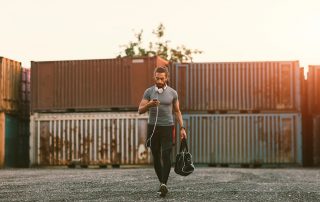 man going to the gym with his gym bag in hand