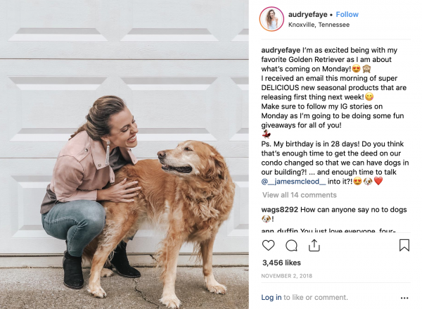 Audrye posing with her golden retriever for an Instagram post