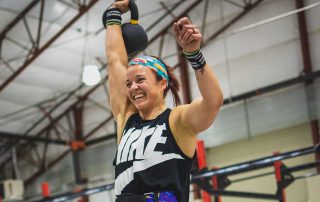 Kayla Johnson smiling while at a fitness competition.