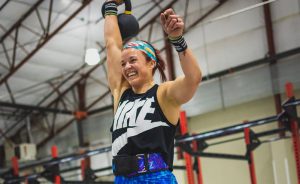 Kayla Johnson smiling while at a fitness competition.