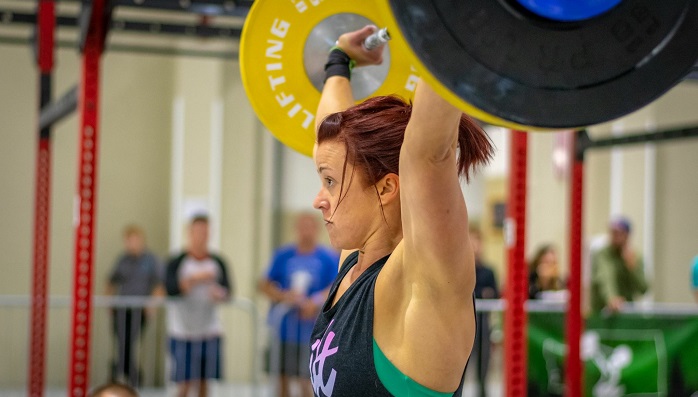 Kayla Johnson powerlifting at a competition.