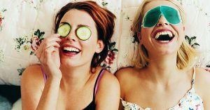 wo girls laughing, enjoying an at-home spa day