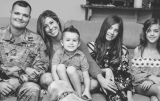 Christie Nix sitting on the couch with her family