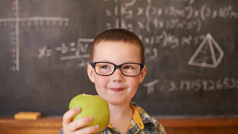 Boy with glasses Holding Apple