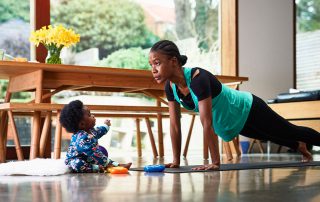 woman in plank with toddler: work/life balance
