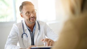 Doctor talking to patient over table