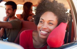 young woman looking out of car window