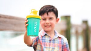 Young boy holding IsaKids shaker bottle