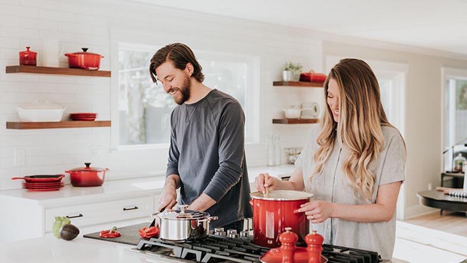 couple in kitchen cooking