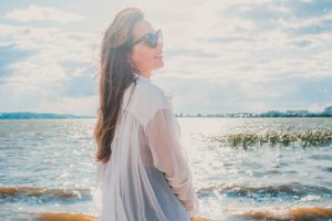 Woman next to water in the sun