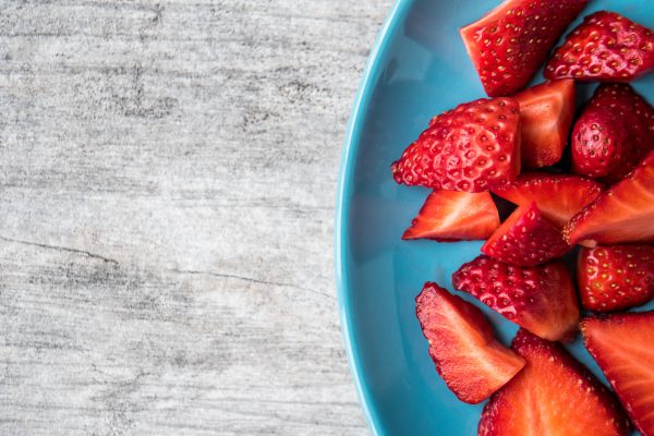 strawberries on teal plate