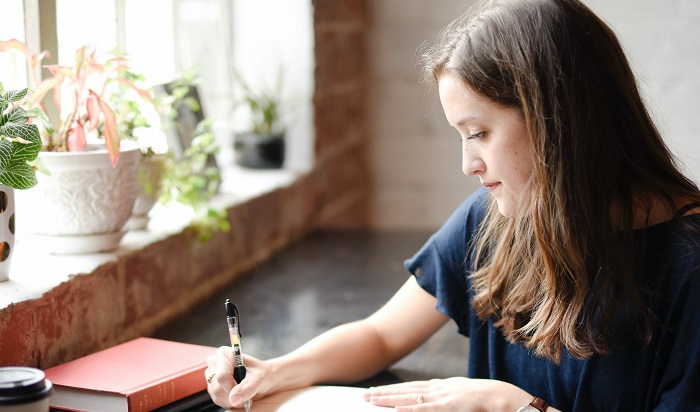 Woman writing in journal