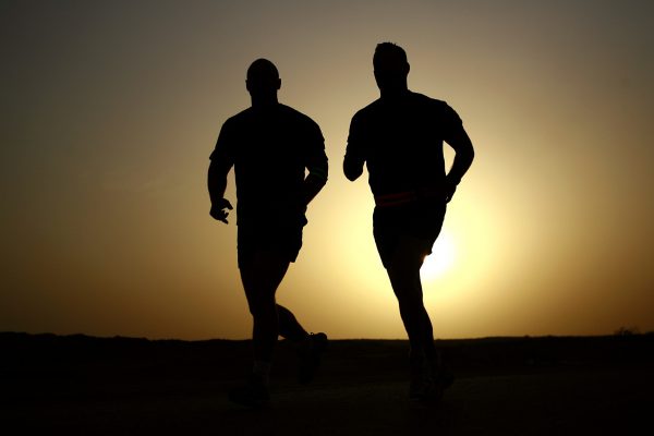 Men running in sunset