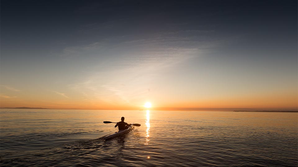 Person canoeing on ocean