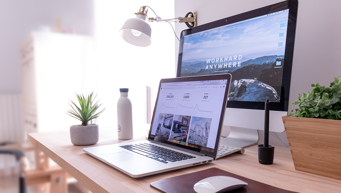 A laptop and computer monitor on a desk