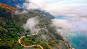 Sky view of road in the mountains near the ocean