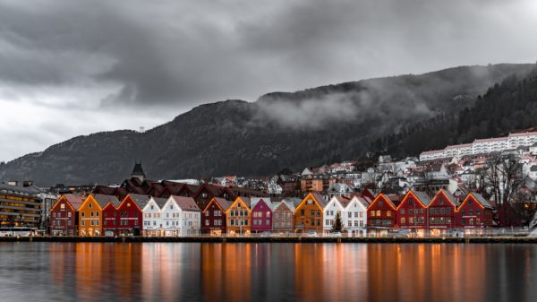 Red, orange, and white Swedish homes on the water