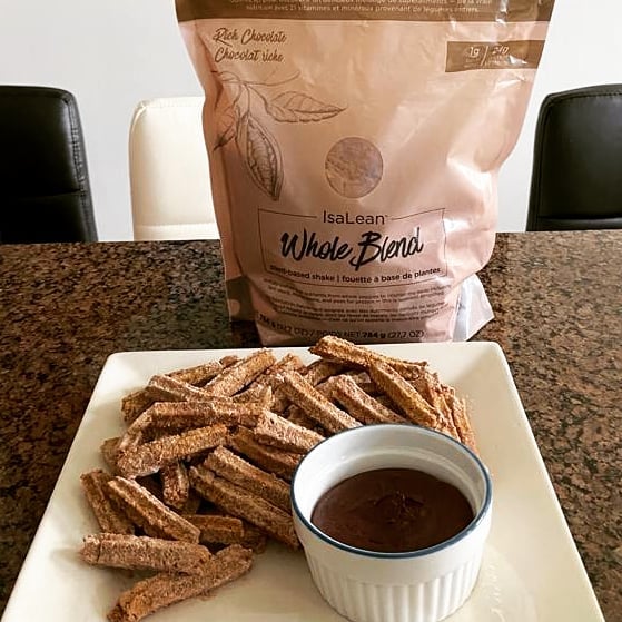 Rich Chocolate Plant-Based Whole Blend IsaLean Shake, churros, and chocolate sauce