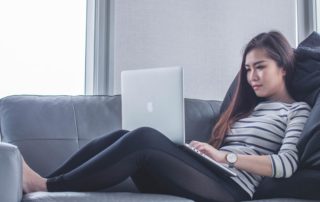 A woman on her laptop on the couch