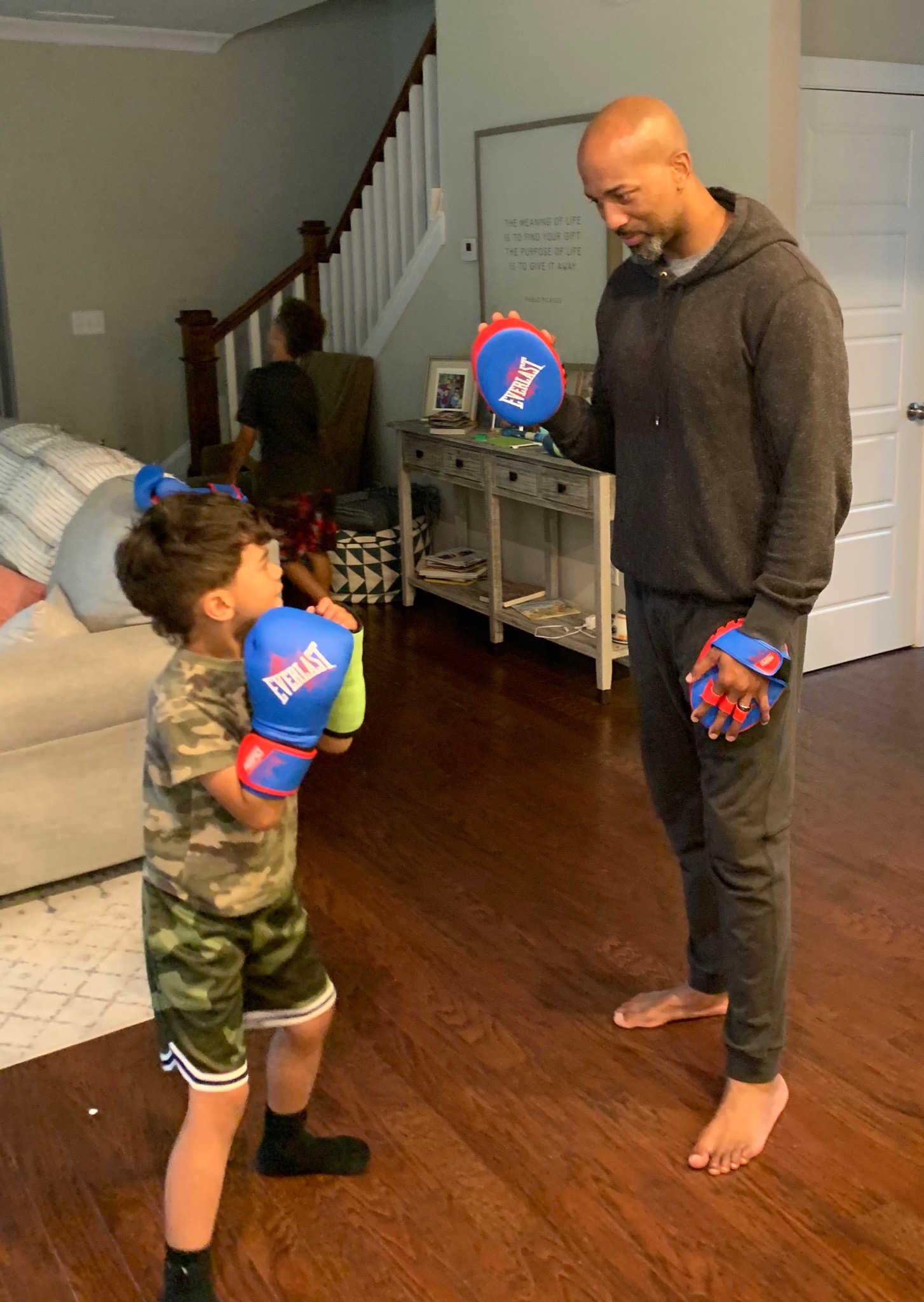 Charles Payne and his son boxing in the living room