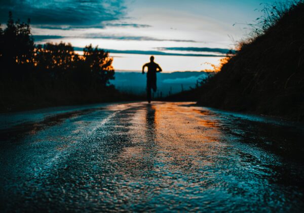 Man running into sunset