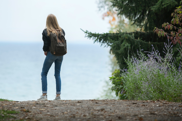 Woman on a morning hike looking out on the water