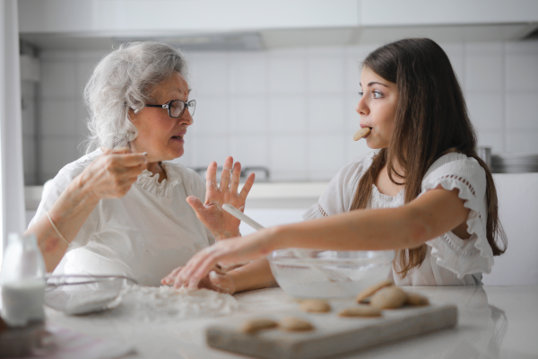 Granddaughter snacking on chocolate chip cookies with her grandma