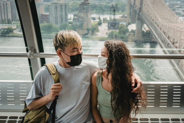 Man and woman socializing with face masks on